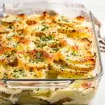 Creamy garlic parmesan scalloped potatoes with golden brown layers and melted cheese.