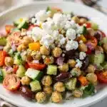 Creamy Mediterranean chickpea salad with crisp vegetables and glossy dill dressing