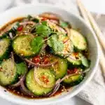 Crisp spicy Asian cucumber salad with sesame dressing and fresh cilantro.