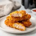 Crispy air fryer chicken tenders with golden panko coating and honey mustard sauce.