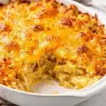 Easy crockpot cheesy hashbrown casserole with melted cheese and crispy potatoes.