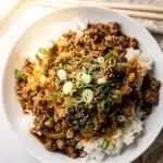 Easy Korean ground beef bowl with glossy sauce over rice and green onions.