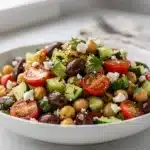 Fresh Mediterranean chickpea salad with feta tomatoes olives and lemon dressing
