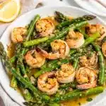 Garlic butter shrimp and asparagus skillet with creamy sauce close up