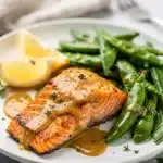 Honey Dijon salmon with crisp snap peas in a vibrant close up photo