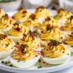 Creamy deviled eggs with bacon ranch filling topped with crispy bacon bits