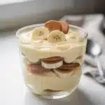 No bake Magnolia Bakery banana pudding in a clear layered trifle bowl