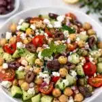 Chopped Mediterranean chickpea salad with cucumbers tomatoes feta and creamy dressing
