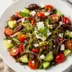 Fresh Mediterranean lentil salad with creamy feta and glossy olives close up