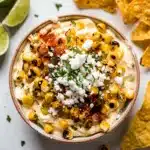 Creamy Mexican street corn dip with cotija cheese and chili powder.
