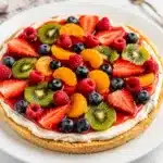 No bake fruit pizza with fresh berries and kiwi on a creamy sugar cookie crust.