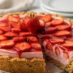 Easy no bake strawberry pie with creamy filling and fresh fruit garnish.