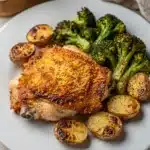 Crispy Parmesan crusted chicken with roasted potatoes and broccoli dinner.