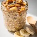 Creamy peanut butter banana overnight oats in a clear glass jar