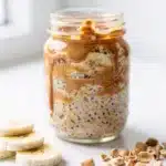 Creamy peanut butter banana overnight oats in a mason jar with chia seeds