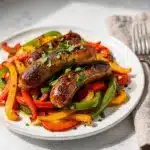 One pan sausage and peppers recipe with glossy browned sausages and tender peppers.