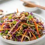 Colorful sesame ginger slaw salad with crunchy almonds and ramen noodles