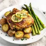 Juicy lemon garlic chicken with crispy potatoes and asparagus on sheet pan