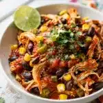 Creamy salsa chicken with black beans in a slow cooker meal.