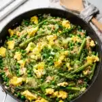 Colorful spring vegetable fried rice recipe with glossy sauce and crispy textures.