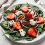 Strawberry goat cheese spinach salad with pecans and balsamic vinaigrette.