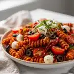 Sun dried tomato pesto pasta salad with mozzarella olives and fresh basil