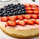 American flag strawberry cheesecake with glossy berry glaze