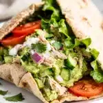 Creamy avocado chicken salad stuffed in a soft whole wheat pita pocket.