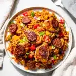 Cajun chicken and andouille jambalaya in rustic cast iron skillet