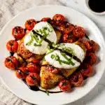 Golden brown baked chicken topped with melted mozzarella and fresh basil caprese.