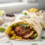 Chipotle lime grilled chicken burrito wrap with avocado and fresh cilantro.