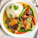 Creamy coconut curry braised chicken thighs with bell peppers and snap peas