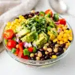 Cowboy caviar dip with beans corn and vegetables in a rustic ceramic bowl