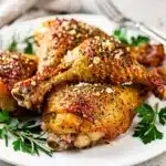 Crispy herb baked chicken legs with golden parmesan crust and lemon.