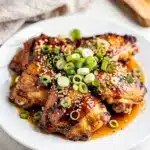 Grilled Hawaiian Huli Huli chicken with glossy caramelized sauce and pineapple garnish.