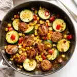 Rustic skillet with summer sausage and vegetable medley in tomato sauce.