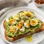Smashed avocado and egg toast recipe with creamy textures and vibrant colors.