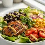 Colorful Southwest chicken salad bowl with creamy avocado and lime dressing