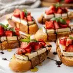 Strawberry brie bruschetta with basil and balsamic glaze on toasted baguette
