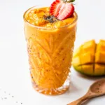 Strawberry mango protein smoothie close up creamy tropical recipe.