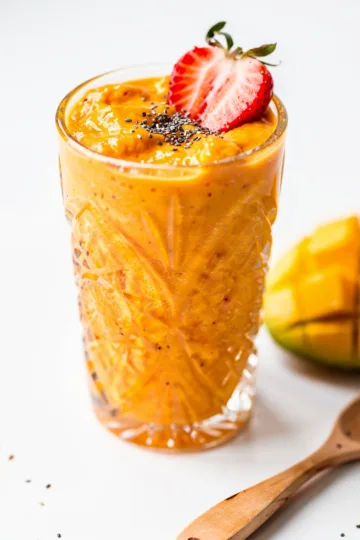 Strawberry mango protein smoothie close up creamy tropical recipe.