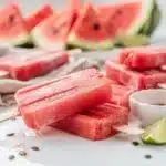Refreshing watermelon sorbet popsicles on a bright clean summer table.