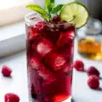 Refreshing hibiscus raspberry iced tea with fresh berries