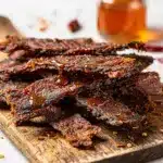 Honey BBQ Beef Jerky close-up on rustic wooden board