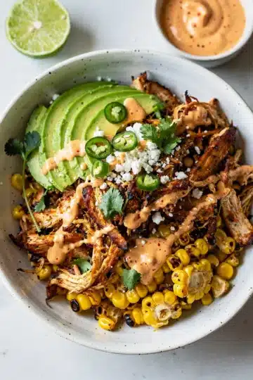 Leftover BBQ chicken street corn bowl with creamy sauce.